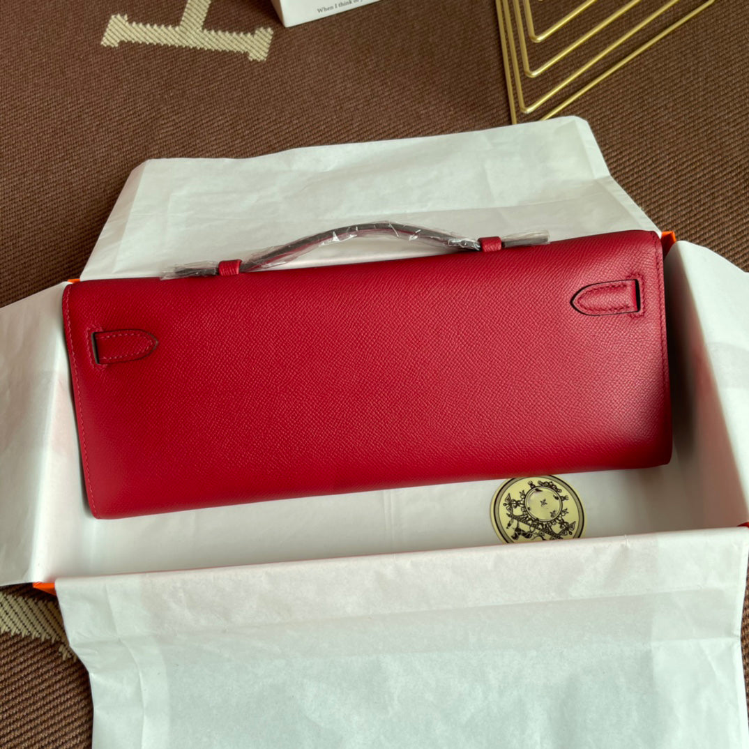 Vivid Scarlet Elongated Twist-Lock Hand Clutch With Polished Golden Hardware And Slim Curved Top Handle