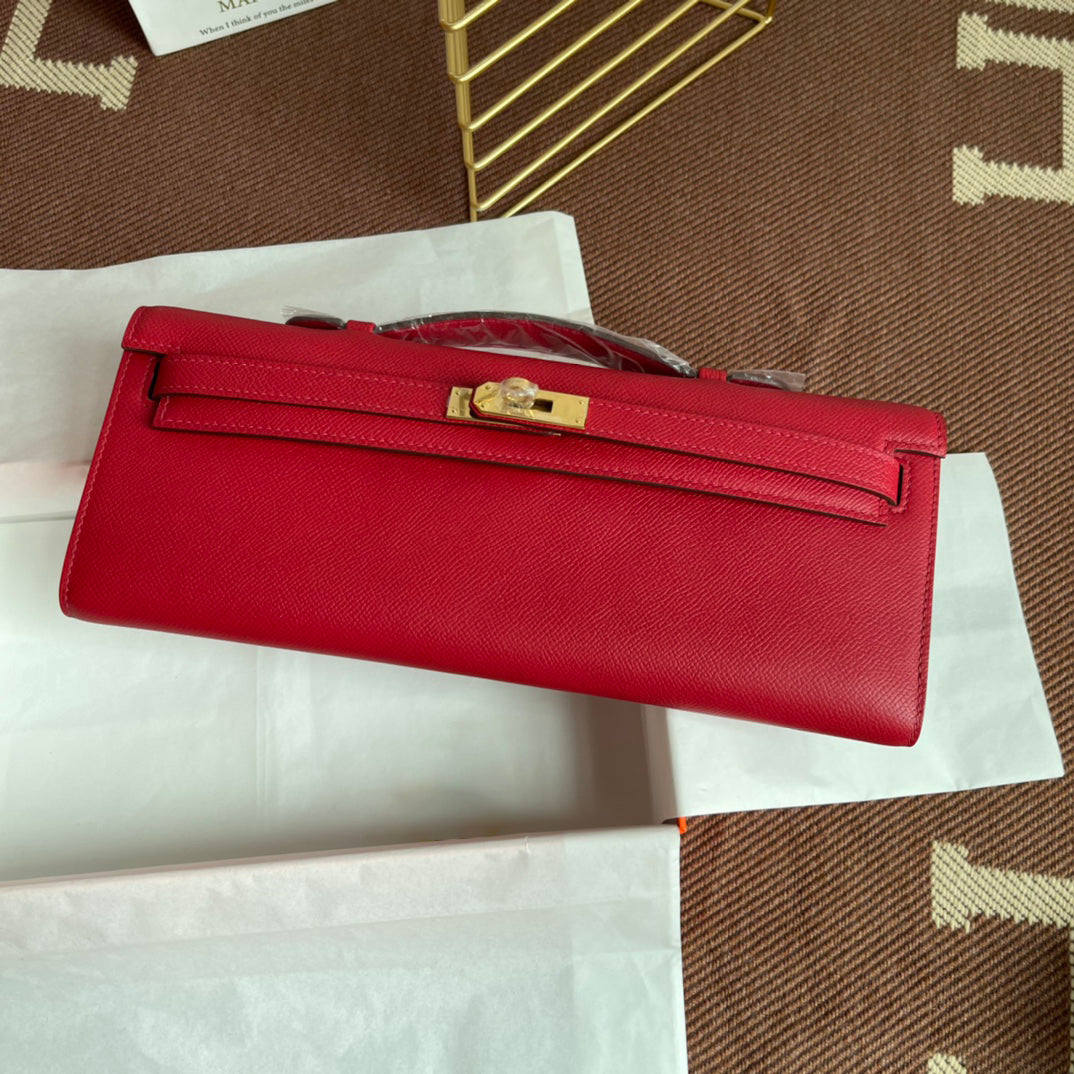 Vivid Scarlet Elongated Twist-Lock Hand Clutch With Polished Golden Hardware And Slim Curved Top Handle