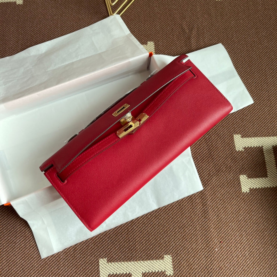 Vivid Scarlet Elongated Twist-Lock Hand Clutch With Polished Golden Hardware And Slim Curved Top Handle