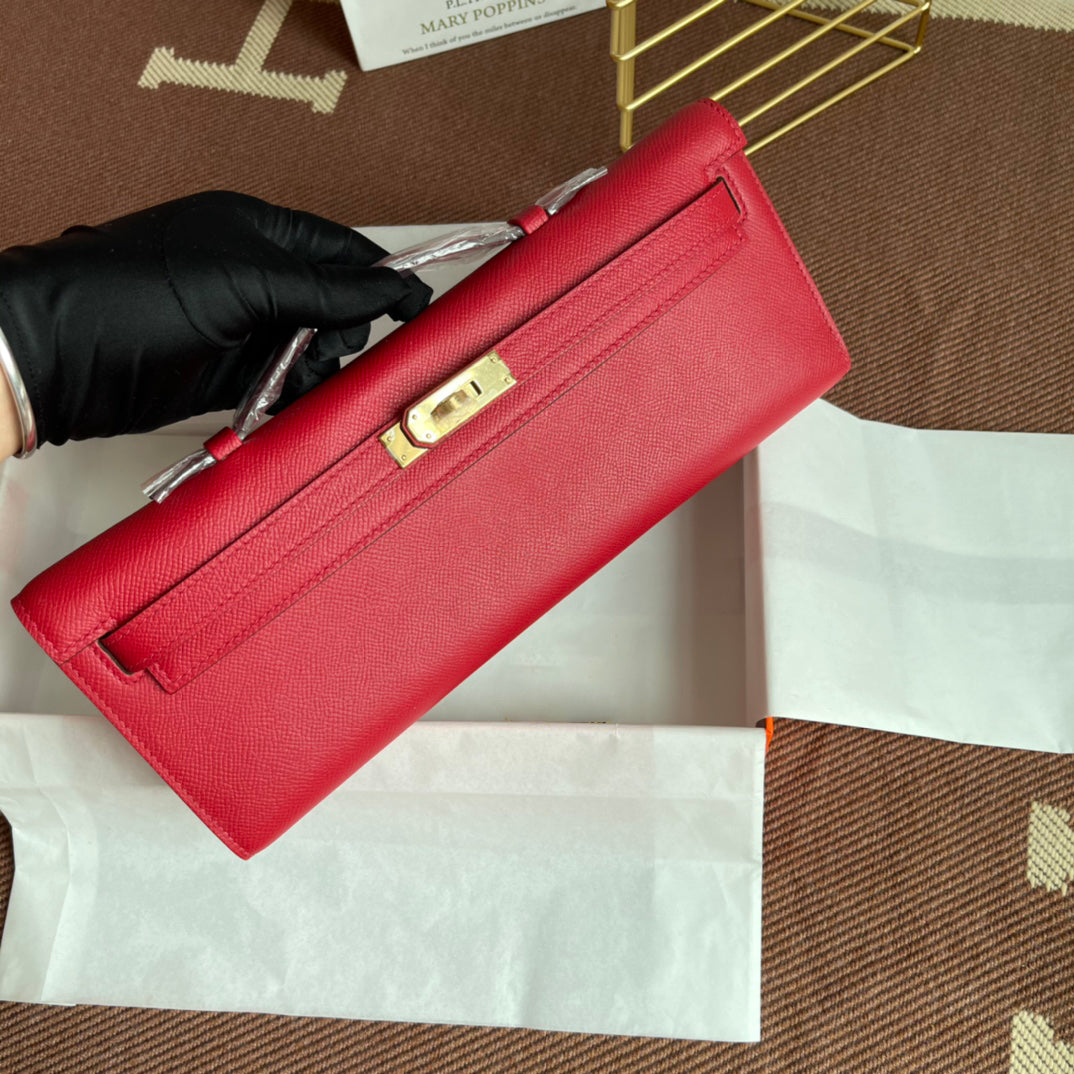 Vivid Scarlet Elongated Twist-Lock Hand Clutch With Polished Golden Hardware And Slim Curved Top Handle